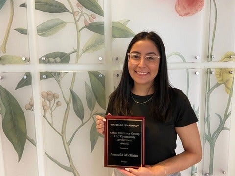 Amanda Michano holding her award