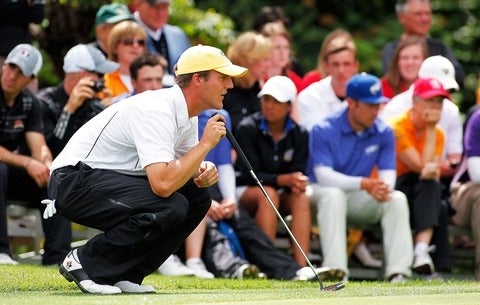 Garrett Rank lining up a putt.