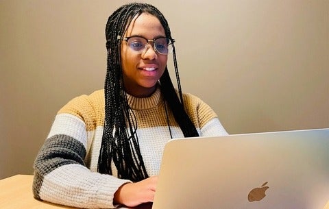 Avonae using her laptop