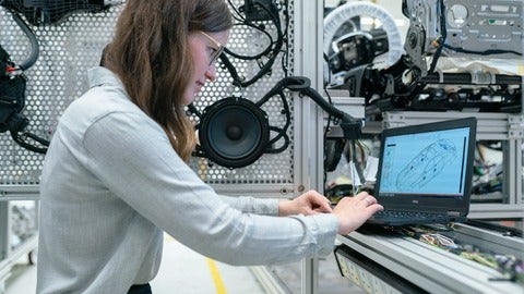 female student working in auto lab