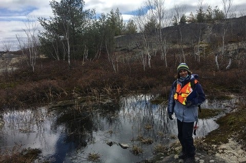 Sana Ahmad standing beside a pond