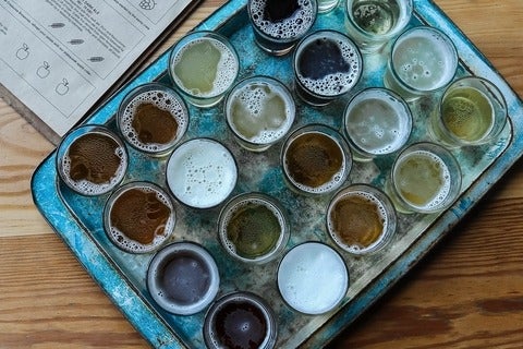 Tray of glasses, filled with frothy beer