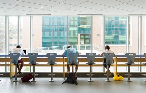 Students sitting at window