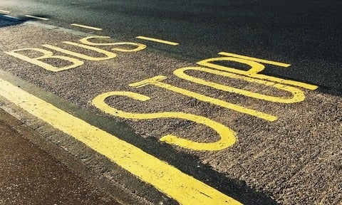 bus stop printed on asphalt (photo by Suzy Hazelwood)