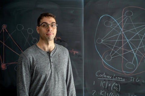 Cameron Seth standing in front of blackboard