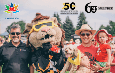 President Feridun Hamdullahpur with King Warrior and a man holding a child and a dog at Canada Day festivities