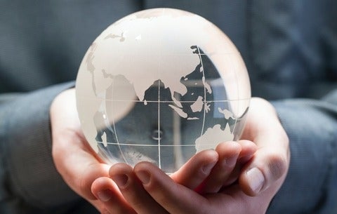 Transparent globe held by hands