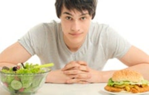 Man debates between eating a salad, or burger and fries
