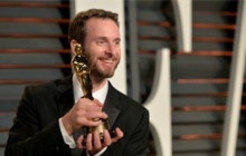 Chris Williams holding his award