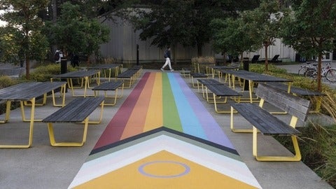 Person walking at the pride crosswalk.