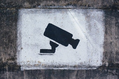 An illustration of a security camera spray painted on a wall