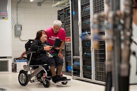 Peter Chai and Martin Karsten sharing a laugh near server rack