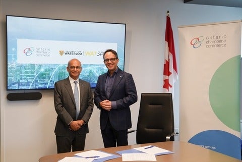 Waterloo president Vivek Goel and Ontario Chamber of Commerce president Daniel Tisch pose following the signing of an MOU