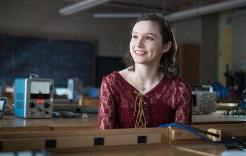 Emily Pass smiling into the distance in the UW physics lab.