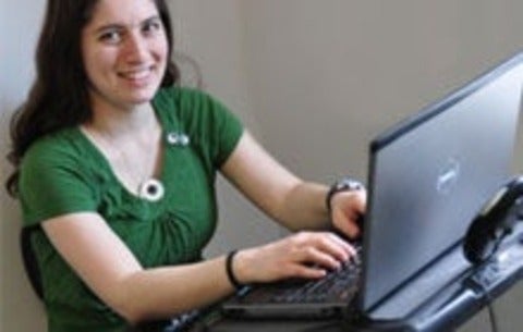 student working on computer on a bike