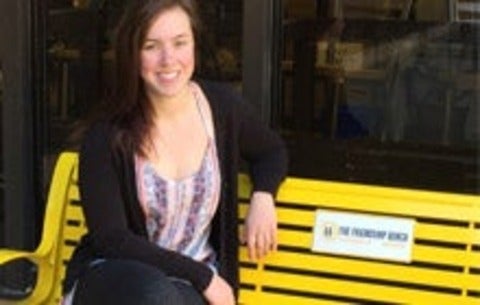 Hannah sitting on the designated friendship bench