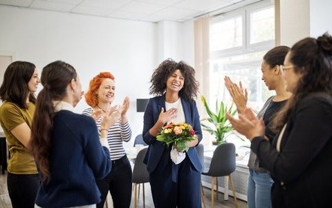 Businesswomen celebrating an achievement of a colleague