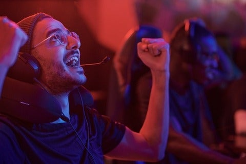 Emotional esports gamer making yes gesture