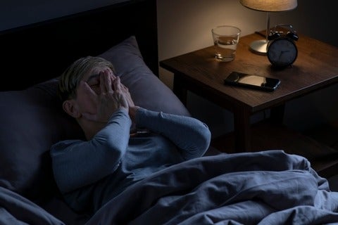 A senior person lying in bed, unable to sleep. (Getty Images/Filmstax) 