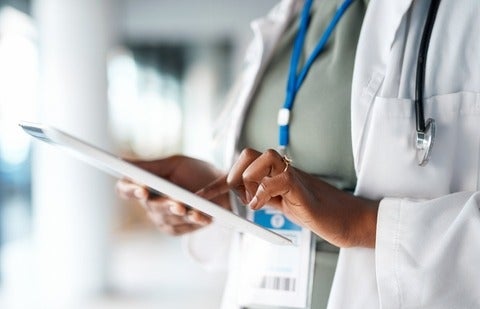 Doctor using an iPad to check on patient results