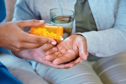 Nurse giving patient their pills