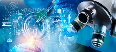 A scientist works with a pipette and a test tube in a medical research lab.