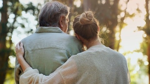 Two people hugging lovingly in a park
