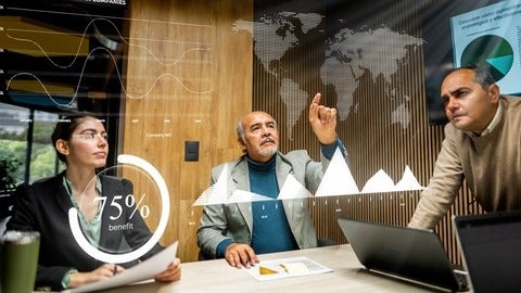 Team of executive leaders pointing at a hologram of the world map 