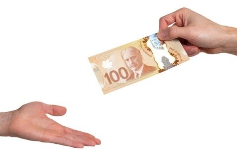 A CAD100 being passed from one hand to another