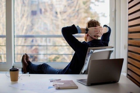 Businessman sitting in the office and looking through the window