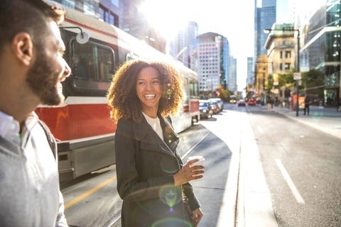 Man and woman crossing busy street in Toronto