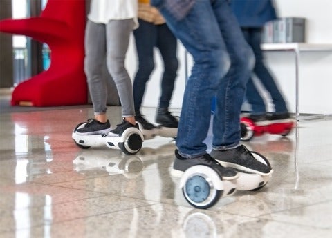 Legs of people riding hoverboards