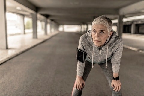 Portrait of a woman fighting breast cancer, resting after jogging. 
