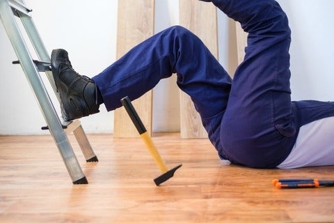 Construction worker falling down a ladder