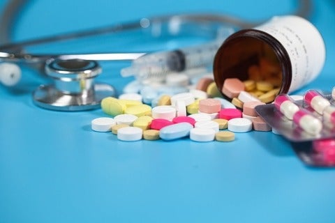 Drug with colourful pills and blue background
