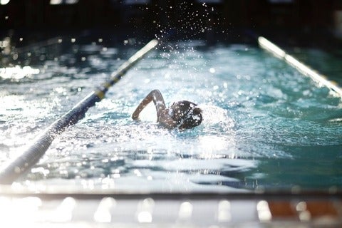 Child competing in swimming race in pool