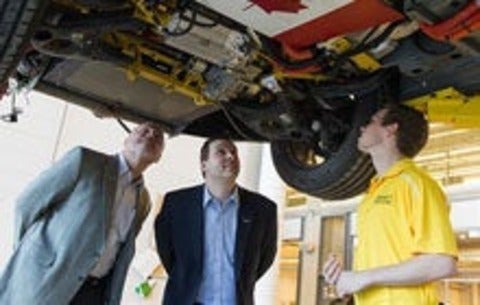 Vice President Ken Kelzer and Executive Director Brandon Vivian examine vehicle modifications
