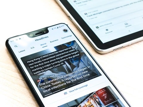 A mobile phone displaying the Ground News website