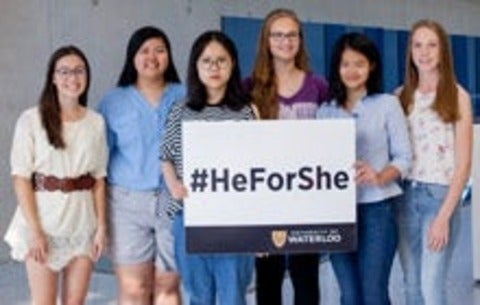HeForShe scholarship recipients standing with #HeForShe sign