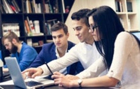 Trio of students working on a computer