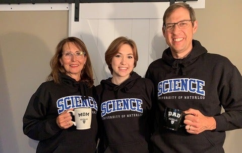Jocelyn Hadden with her parents Susan and James, all in Waterloo Science sweaters