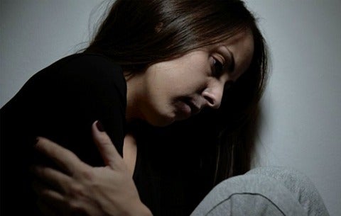 Sad girl holding herself