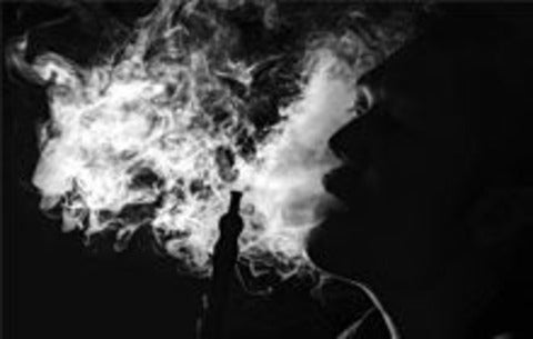 man blowing smoke