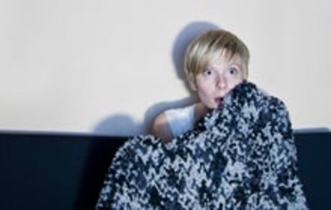 Woman watching a scary movie