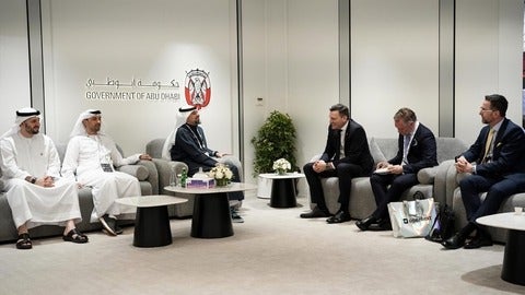 Mark Schaan seated with AI Minister, the Honourable Evan Solomon, in October 2025 with delegates from Abu Dhabi