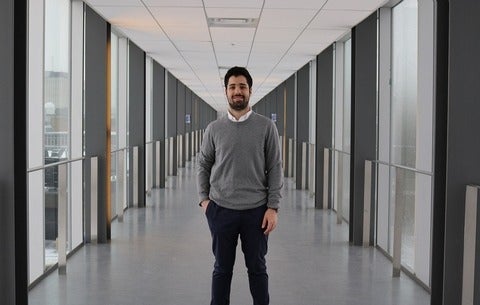 Boy standing in the middle of a hallway 