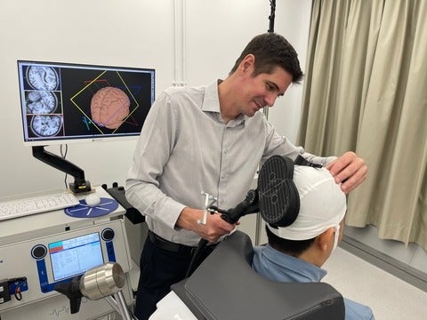Dr. Ben Thompson performing a brain stimulation procedure on a patient