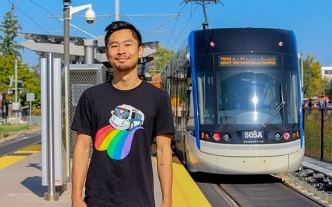 Rodney Chan standing on the ION platform with train behind him