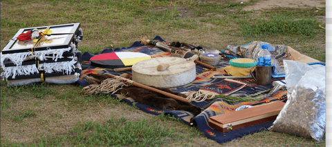 A drug and various Indigenous items on a blanket