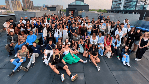 A group of students pose on a rooftop